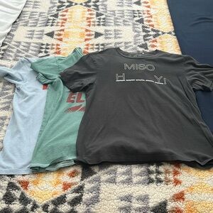 Bundle of three Guess Men’s Medium t-shirts. Light blue, green, and black.